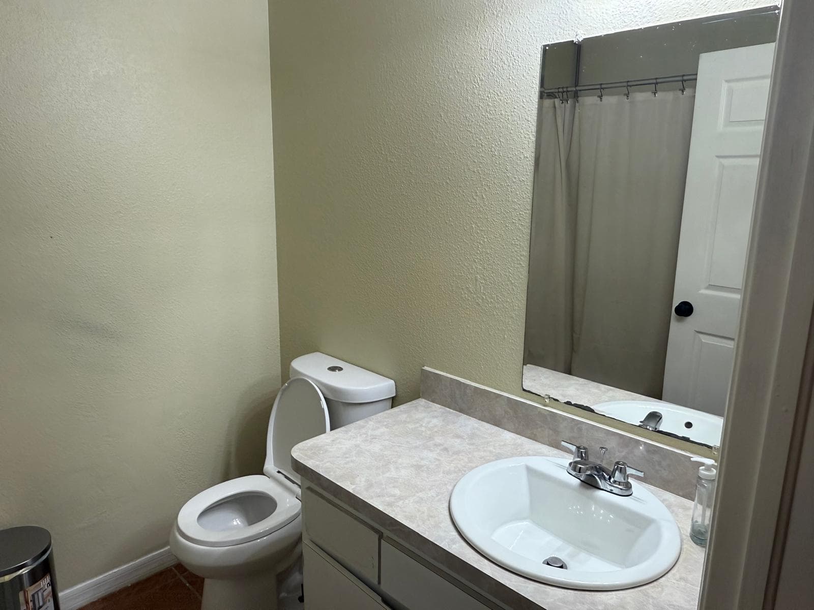 Second bathroom with vanity, mirror, and shower at ADOL FOSTER HOME in Tampa.