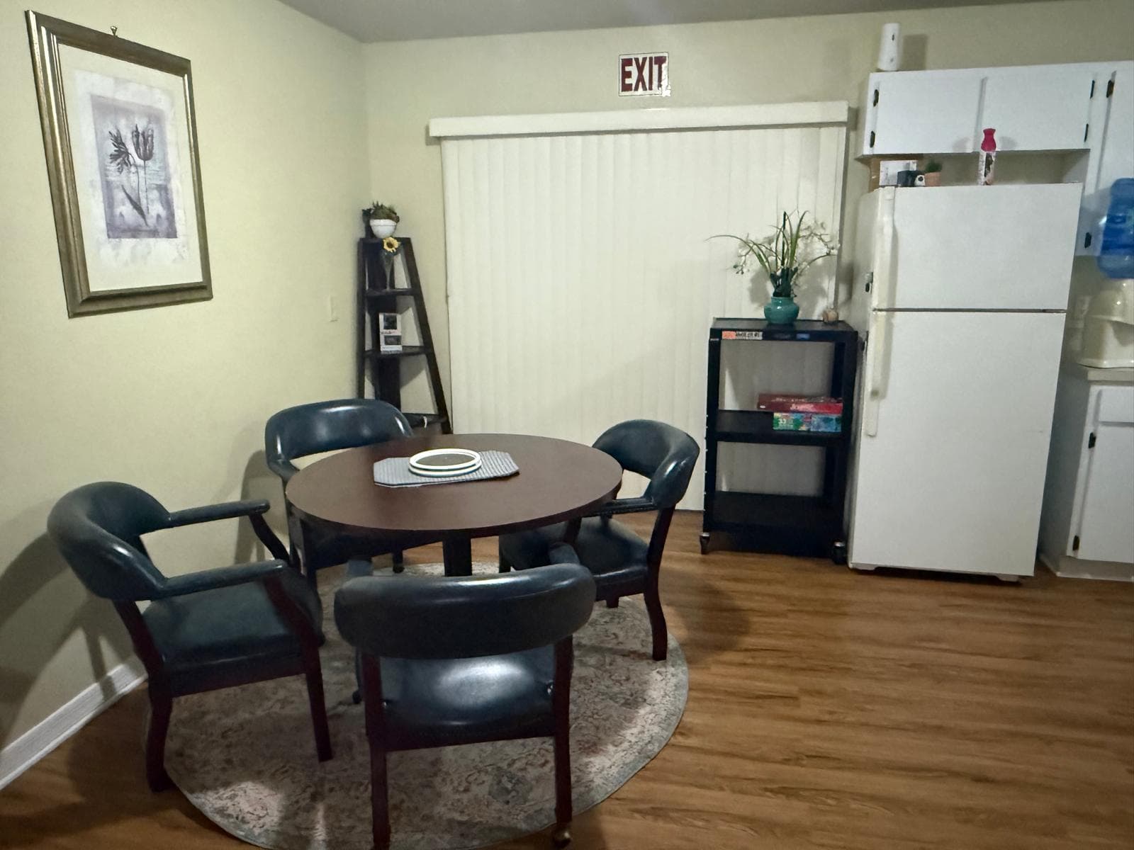 Dining nook with round table and chairs near the kitchen at ADOL FOSTER HOME in Tampa.