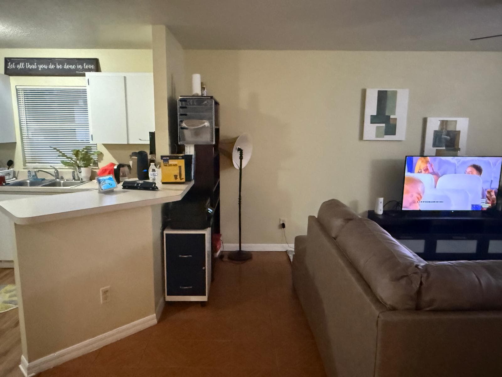 Living room with sofa next to the kitchen breakfast bar at ADOL FOSTER HOME in Tampa.